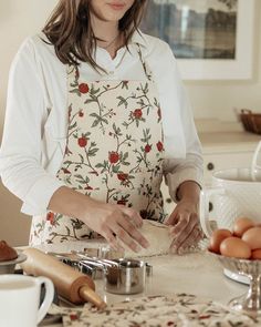 The perfect addition to keep your clothing safe in the kitchen, while looking guest-ready. Thoughtful details include a charming ruffle hem, convenient pockets, and adjustable ties. The hand-drawn Bloom print is beautifully showcased on a slub textured, organic cotton fabric, offering a soft and durable wear. Woven from 100% organic cotton. Dyes free of harmful chemicals. Sustainably sourced and ethically made in India. Learn more about our commitment to sustainability. Make it uniquely yours wi Apron Dress, Cooking Apron, Organic Cotton Fabric, Harmful Chemicals, Ruffle Hem, Chemicals, Sustainability, Apron, The Kitchen