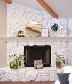 a living room with a fire place and some plants