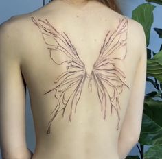 the back of a woman's body with a butterfly tattoo on her left side