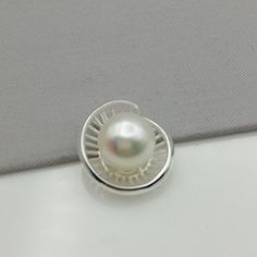 ▪︎ An elegant pendant made with a pearl on a sterling silver base. ▪︎ Size: 12 mm x 18 mm. Pearl size: 10mm Weighs: 3 gm ▪︎ This multi purpose pendant can be used as a charm in necklaces, bracelets, key chains, zip pullers etc. ▪︎ This pendant is handmade with hypoallergenic sterling silver. Most of my pieces are marked with a 925 silver stamp. ▪︎ Please note: This listing is for ONE pendant and comes WITHOUT the chain, however, you can add a snake chain in the required length while making your Silver Jewelry With Round Pearl Pendant, White Oval Pendant Pearl Necklace As Gift, White Pendant Jewelry Stamped 925, Anniversary Pearl Pendant Necklace, Silver Pendant Pearl Necklace For Anniversary, Silver Pendant Jewelry With Pearl Charm, Silver Sterling Silver Pearl Pendant Necklace, Pearl White Sterling Silver Pendant Jewelry, Sterling Silver Pearl Necklace With Pendant For Anniversary