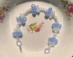 a white plate topped with blue and clear bracelets