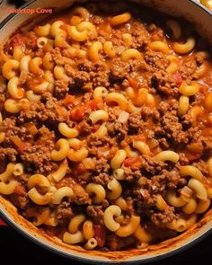 a pot filled with macaroni and cheese on top of a stove