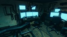 a computer room with multiple monitors and chairs