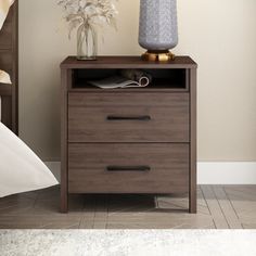 a night stand with two drawers and a lamp