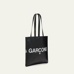 Comme des Garcons tote bag in smooth leather features a "Huge Logo" design Foiled logo lettering Two flat top handles Open top Interior, one zip pocket Approx. 25.984"H  x 15.748"W x 0.787"D Leather Imported Luxury Shoulder Bag With Logo Print For Travel, Luxury Logo Print Shoulder Bag For Travel, Designer Black Bag With Logo Print, Leather Bag With Embossed Logo And Double Handle, Designer Bags With Embossed Logo For Everyday Use, Leather Bag With Double Handle And Embossed Logo, Top Handle Shoulder Bag With Engraved Logo For Shopping, Luxury Rectangular Bags With Logo Print, Luxury Rectangular Bag With Logo Print