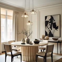 a dining room table surrounded by chairs and vases on top of it in front of a window