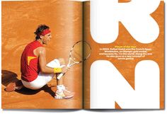 a man sitting on the ground holding a tennis racquet in his hand while wearing red and yellow