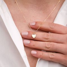 Teeny Tiny Personalised 9ct Gold Heart Necklace A gorgeous, tiny shimmering heart fitted on a delicate chain. A simple yet elegant symbol of love and friendship, which can be either left plain or personalised to make a unique gift. Use as a stand alone piece or add to your favourite chains for an on-trend layering look. Personalisation can be a single initial in the centre or two initials (e.g. V&T) along the side. Chain lengths available in 16in (41cm) and 18in (45cm). FEATURES: * 9ct Recyc Gold Heart Initial Necklace, Dainty 14k Gold Charm Necklace With Heart Charm, 14k Gold Heart Necklace With Delicate Chain For Gift, Personalized Dainty Heart Pendant Charm Necklace, Delicate Tiny Charm Necklaces For Anniversary, Dainty Personalized Heart Pendant Charm Necklace, Simple Charm Necklace For Anniversary, Delicate Heart Charm Necklace With Birthstone, Delicate Heart-shaped Birthstone Charm Necklaces