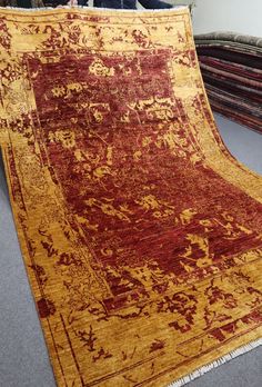 an old rug is laying on the floor next to some other pieces of furniture and carpet