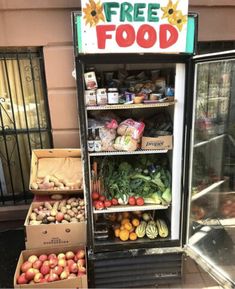 a vending machine with fruits and vegetables in front of it that says free food