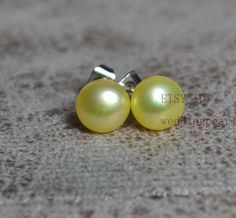 jewelry : yellow pearl earrings, real pearl stud earrings earring material:  freshwater pearl,sterling silver pearl grade: AAA Metal material: sterling silver pearl body: clean pearl luster: high pearl shape: button pearl size: 8mm pearl colour: yellow packaging: beautiful pouch Thank you for your viewing. The other pearl jewelries: https://www.etsy.com/shop/weddingpearl?ref=simple-shop-header-name&listing_id=1026507203&search_query=pearl go to my store: https://www.etsy.com/shop/weddingpearl?re Yellow Pearl Jewelry Gift, Yellow Packaging, Yellow Pearl Earrings, Real Pearl Earrings, Biwa Pearls, Yellow Pearl, Beaded Earring, Freshwater Pearl Earrings, Aquamarine Necklace