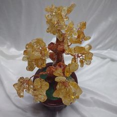 a vase filled with yellow flowers on top of a white cloth