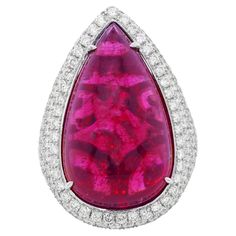 18kt White Gold Pink Tourmaline Cabochon Cut Diamond Ring, Features Gia Certified 36.08ct Pear Shape Pink (Purplish Red) Tourmaline And 6.50ct Of Micropave Round Diamonds Going Three-quarters Of The Way Around Red Tourmaline, Pink Tourmaline, Pear Shape, Jewelry Designs, Earings Piercings, Fashion Rings, Round Diamonds, Tourmaline, Beautiful Jewelry