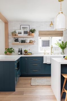 a kitchen with blue cabinets and white countertops is featured in the magazine's march issue