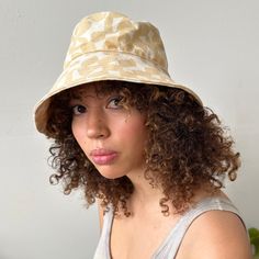 Perfect for a day of fun in the sun, our bucket hat is structured with an extra-wide brim to keep you cool and covered on the go. 100% cotton canvas screen printed with water-based inks Made in California Brim: 3.5" Circumference: 23" To clean: spot clean and/or dry clean. Summer Cotton Sun Hat With Flat Brim, Summer Cotton Bucket Hat With Flat Brim, Summer Brimmed Canvas Sun Hat, Trendy Cotton Sun Hat With Flat Brim, Beige Canvas Bucket Hat For Summer, Cream Brimmed Cotton Bucket Hat, Summer Beige Canvas Bucket Hat, Cotton Bucket Hat With Curved Brim For Beach, Adjustable Wide Brim Canvas Sun Hat