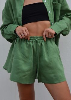 Discover our effortlessly chic forest green linen shorts. Crafted from premium European linen, these shorts offer exceptional softness and comfort. Perfect for a day at the beach, a casual city outing, or relaxed weekend wear. Featuring a wide leg, convenient side pockets, and a comfortable elastic waistband, they're designed to elevate your summer wardrobe. We prioritize quality and sustainability.  Our linen is OEKO-TEX Standard 100 certified, meaning it's free from harmful chemicals. DETAILS:  - Wide Linen Shorts - Loose Fit  - Two side Pockets - Elastic Band  - European Softened Linen  - Handmade in our small studio in Siauliai SIZE IN THE PICTURE:  The model in our photos is wearing a size S. The Model's height is 5'5"/ 165cm. SIZE CHART:  *Please note that this chart indicates garmen Relaxed Fit Solid Shorts For Vacation, Green Relaxed Fit Pajama Shorts With Elastic Waistband, Relaxed Fit Solid Color Shorts For Summer, Green Pajama Shorts With Elastic Waistband, Relaxed Fit, Relaxed Shorts With Pockets For Day Out, Solid Color Summer Shorts With Relaxed Fit, Solid Color Shorts With Drawstring, Solid Color Drawstring Shorts, Summer Relaxed Fit Solid Color Shorts