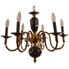 a chandelier with five lights hanging from it's center and four arms