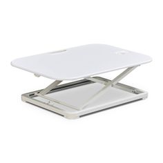 a white laptop computer stand on top of a desk