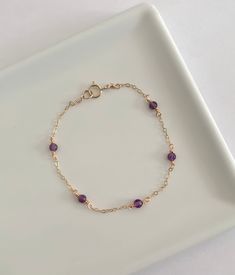 This dainty amethyst bracelet is handmade with genuine amethyst, and 14k gold filled and sterling silver metals. - Each bead measures 3mm. - Waterproof - Will not tarnish - Size up and wear as an anklet All of our jewelry is handmade with love in Nova Scotia, Canada. METALS Our jewelry is made using 925 sterling silver or 14k gold filled metals. Gold filled metals are made with a thick layer of gold to a brass core. Is is of higher quality than plated jewelry, and is a great alternative to pure Elegant Purple Birthstone Beaded Bracelets, Purple Beaded Birthstone Bracelets As Gift, Purple Beaded Birthstone Bracelets For Gift, Purple Birthstone Beaded Bracelets As Gift, Purple Birthstone Beaded Bracelets For Gift, Purple Wire Wrapped Bracelet, Adjustable Amethyst Beaded Bracelets With Birthstone, Spiritual Purple Birthstone Bracelets, Wire Wrapped Amethyst Bracelets In Purple