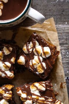 there are chocolate brownies with marshmallows on top and a cup of coffee