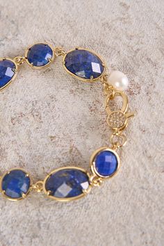 Add a touch of sophistication to your outfit with our Lapis Lazuli Stone Bracelet. Featuring shimmering, round and oval-shaped lapis lazuli gemstones with a gold finish, this bracelet will instantly elevate your style. Elegant Sapphire Faceted Bracelets, Gold Lapis Lazuli Bracelet With Gemstone, Gold Lapis Lazuli Gemstone Bracelet, Elegant Bracelets With Natural Stones, Elegant Natural Stones Oval Bracelet, Elegant Blue Lapis Lazuli Bracelet, Elegant Blue Faceted Bracelets, Elegant Lapis Lazuli Gemstone Bracelets, Lapis Lazuli Stone