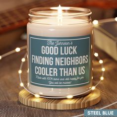 a candle that reads, good luck finding neighbors cooler than us