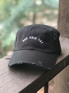 We all have em Swap the dry shampoo for this cute and stylish slightly distressed black dad hat Embroidered with white polyester thread Hat is adjustable on the back with a fabric strap One size fits most Ships in 3-4 business days Dad Hat, Bad Hair Day Hat, Edgy Fashion Chic, Store Design Boutique, Tshirt Printing Design, Edgy Chic, Embroidered Hats, Bad Hair Day, Bad Hair