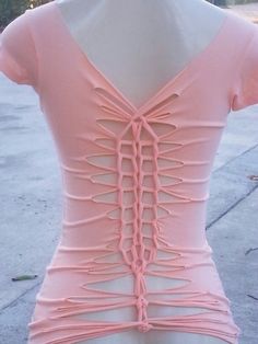 the back of a woman's pink top with ruffles on it