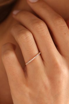 a woman's hand with a diamond ring on it