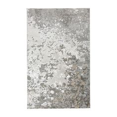 a gray and white rug with lots of dirt on it