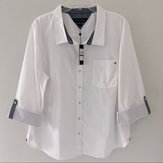 New With Tags Nwt Tommy Hilfiger White Heritage Roll-Tab Button-Up Shirt. Size 2xl. A Few Areas Of Faint Marks, As Pictured, That Can Be Removed Once Washed. No Other Flaws. Measurements: Armpit To Armpit 24” Length 28” Elegant White Tommy Hilfiger Tops, Tommy Hilfiger Long Sleeve Blouse, Tommy Hilfiger Casual Cotton Blouse, Tommy Hilfiger Long Sleeve Blouse For Spring, Elegant Long Sleeve Tommy Hilfiger Tops, Tommy Hilfiger Button-up Summer Tops, Tommy Hilfiger Summer Button-up Top, Elegant Long Sleeve Tops By Tommy Hilfiger, Tommy Hilfiger Button-up Tops