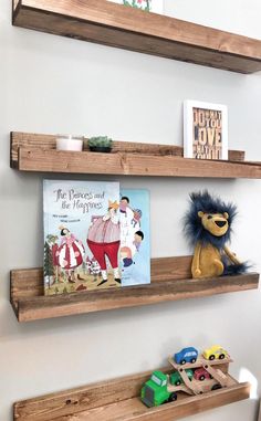 two wooden shelves with books and toys on them