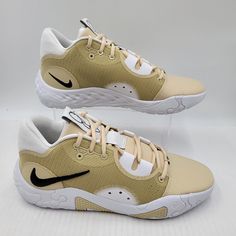 a pair of beige and black nike sneakers