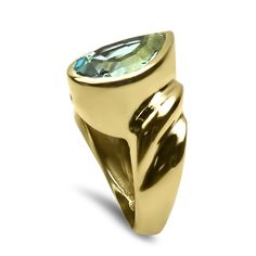 Elevate your style with our 14K Yellow Gold Pear-shaped Blue Topaz Fashion Ring—a statement of sophistication and elegance. The centerpiece is a lustrous pear-shaped blue topaz, weighing a substantial 6.33cts and measuring 14.8mm x 9.8mm x 6.2mm. Its very slightly greenish-blue color exhibits a mesmerizing medium tone and moderate saturation, creating a captivating allure (vslB 5/4).Set on the bias in a ribbed bezel, the blue topaz takes center stage, embraced by a polished, open-backed mounting Formal Yellow Gold Topaz Teardrop Ring, Formal Pear-shaped Topaz Ring, Formal Blue Pear-shaped Topaz Ring, Gold Teardrop Topaz Ring For Formal Occasions, Formal Teardrop Blue Topaz Ring, Formal Pear-shaped Blue Topaz Ring, Elegant Pear-shaped Topaz Ring For Formal Events, Elegant Pear Shaped Topaz Ring For Formal Occasions, Greenish Blue