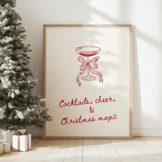 a christmas tree with presents under it next to a poster that says cocktail, cheer and christmas magic