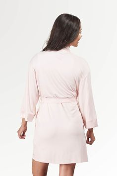 Our Kimono robe is new and improved. Same classic kimono inspired look. Same soft-as-butter bamboo fabric. Enhanced shape and silhouette with a more fitted shoulder line, inside ties to keep you covered, and pockets for your beauty secrets. The wide satin trim tops off this elegant Bamboo robe, making it the perfect dressing gown or quick throw-over for when guests show up early for coffee. Wide satin trim on the cuffs and neckline add elegance to this basic cozy robe with side pockets and inside ties to keep things closed up. Quick throw-over style to feel elegant and covered when unexpected morning coffee guests pop by. True to size in 2 sizes. S/M fits size US 4-10, L/XL fits US 12-20. Looking for more of an every day cardigan? Check out our Bamboo Swing Jacket! Bell Sleeves Top, Kimono Wrap, Soft Pink Color, Throw Over, Trim Top, New And Improved, Fine Yarn, Bamboo Fabric, Dressing Gown