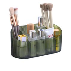 an assortment of cosmetics and makeup brushes in a holder