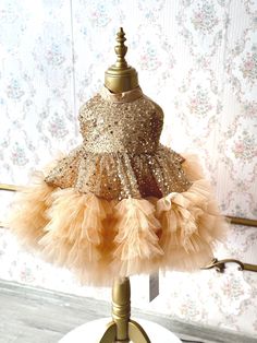 Our enchanting gold sequin tulle dress, is perfectly tailored for your little princess. This hand-crafted dress is made with high quality craftsmanship and perfect for your little one's any special occasion such as birthdays, weddings or for photoshoots. Also an ideal gift option for your family's new little member or for your loved ones' babies! ♥ If you want a custom design (in different color, size, fabric, model etc.), please contact us so we can create your dream piece together! * FABRIC: Gold Sequin and Tulle, for your little princess to shine like a star in her puffy yet light dress. * LINING: 100% Organic Soft Cotton (pre-washed and ironed), ensuring utmost comfort for your little one. * DETAILS: Seams are locked and reversed so that it will not touch your baby's skin and cause irr Gold Princess Pageant Dress For Dress-up, Festive Gold Tulle Dress, Gold Embellished Tulle Dress, Elegant Gold Princess Dress For Party, Elegant Fitted Gold Pageant Dress, Fitted Gold Princess Dress For Festive Occasions, Gold Fitted Princess Dress For Festive Occasions, Festive Fitted Gold Princess Dress, Fitted Gold Pageant Dress