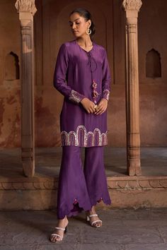 Purple full sleeves short kurta with persian mural embroidery using beads, cut dana, sequins highlights and dori tie-up neckline. Paired with an embellished border flared pant. - Aza Fashions Purple Long Sleeve Sets With Mirror Work, Silk Palazzo Set With Mirror Work And Long Sleeves, Traditional Festive Palazzo Set With Naqshi, Traditional Palazzo Set With Naqshi For Festive Occasions, Traditional Palazzo Set With Naqshi For Eid, Traditional Eid Palazzo Set With Naqshi, Purple Long Sleeve Palazzo Set With Resham Embroidery, Embroidered Long Sleeve Purple Palazzo Set, Traditional Long Sleeve Palazzo Set For Navratri