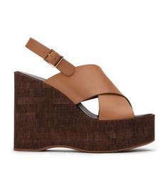 Your warm weather wardrobe isn't complete without Vogue. Simplistic in design, this wedge is on ode to the 70's featuring an adjustable ankle strap and thick crossover strap detailing. -Material: Leather -Sole: Man-Made -Fit: True to Size -Toe-shape: Open -Features: Wedge Heel -Heel: 13cm Modern Brown Wedge Sandals For Spring, Summer Cross Strap Wedge Sandals With Wrapped Heel, Summer Wedge Sandals With Wrapped Heel And Cross Strap, Modern Wedge Sandals With Wrapped Heel For Spring, Spring Cross Strap Wedge Sandals With Heel Loop, Brown Wrapped Heel Wedge Sandals For Spring, Brown Wedge Sandals With Wrapped Heel For Spring, Brown Cross Strap Heels For Summer, Thigh High Boots Flat