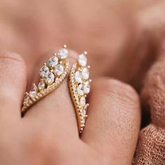 a close up of two rings on someone's finger with diamonds in the middle