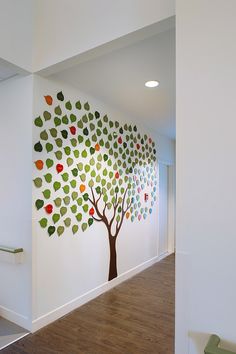 an office with a tree painted on the wall