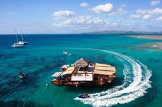 an aerial view of a boat traveling in the ocean