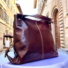 "This bag has been made of the best genuine leather by local master crafters of Florence in Italy, designed for women who only accept premium Italian quality and luxury leather bags and modern Italian fashion. . Sizes: Width: 27 cm / 10.7 inches Height: 31 cm / 12.2 inches Depth: 13 cm / 5.2 inches Color: Dark Brown . The story of this bag: In the enchanting city of Florence, renowned for its artistic heritage and exquisite craftsmanship, a tale unfolds about an elegant leather bag that captures the essence of Italian luxury. Handcrafted with utmost care and attention to detail, this premium leather bag embodies the timeless allure of Florence. Every stitch, every fold, and every delicate touch in the creation of this Florence leather bag is a testament to the skilled artisans who pour the Elegant Everyday Leather Backpack With Smooth Grain, Elegant Leather Backpack With Smooth Grain, Elegant Soft Leather Shoulder Backpack, Elegant Soft Leather Shoulder Bag Backpack, Elegant Soft Leather Backpack Shoulder Bag, Elegant Leather Backpack As Shoulder Bag In Soft Leather, Elegant Leather-backed Hobo Bag For Travel, Elegant Hobo Bag With Leather Backing For Travel, Elegant Travel Hobo Bag With Leather Backing