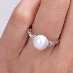 Featuring a lustrous freshwater cultured pearl and dazzling diamond side stones, this Stella Grace ring is a stylish complement to your wardrobe.Click on this JEWELRY & WATCHES GUIDE to learn about fit, styles, materials and more! Width: 8.4 mm Metal: sterling silver Plating: rhodium Finish: polished Packaging: boxedDIAMOND DETAILS Total weight: 1/8 ct. Shape: round Setting: prongCULTURED PEARL DETAILS Type: freshwater Size: 8 mm - 8.5 mm Shape: round Color: white Diamond weights are approximate Classic Pearl White Diamond Ring, Fine Jewelry Diamond White Pearl Ring With Prong Setting, Diamond White Pearl Ring With Prong Setting, Brilliant Cut Diamond White Pearl Ring, White Diamond Ring With Diamond Accents, White Pearl Rings With Diamond Accents, White Gold Pearl Ring With Diamond Accents For Promise, Diamond White Pearl Ring With Diamond Accents For Promise, White Akoya Pearl Diamond Ring With Brilliant Cut