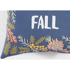 an embroidered pillow with the word fall on it