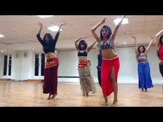 a group of women dancing on top of a wooden floor