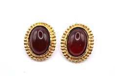 "DESCRIPTION: These stunning designer earrings, created by Edouard Rambaud Paris in the 1980s, are a true testament to French Couture craftsmanship. The earrings feature oval-shaped deep red poured glass cabochons, elegantly set on a gold tone metal base with exquisite framing detailing. Marked with \"EDOUARD RAMBAUD PARIS,\" these earrings are in excellent condition, radiating a timeless elegance. Measuring 1 1/4\" in length and 1 1/8\" in width, they are a sophisticated accessory that will eff Red Formal Costume Jewelry Earrings, Red Costume Jewelry Earrings For Formal Occasions, Vintage Cabochon Earrings For Formal Occasions, Vintage Cabochon Earrings For Evening, French Couture, Cabochon Earrings, Handcrafted Bracelets, Lovely Ring, The 1980s