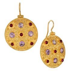 This ornamental geometric design, from the 6th century AD, is based on an original pendant disc crafted of gold filigree. Bejeweled with amethyst and garnet stones, the Museum reproductions are hand crafted of filigree wire. 24k gold vermeil. Size: 1 5/8" Elegant Ceremonial Jeweled Earrings, Byzantine Round Hallmarked Jewelry, Ceremonial Gold Gemstone Earrings, Byzantine Style Gold-plated Round Jewelry, Oval Jeweled Gold Jewelry, Opulent Gold Earrings As Gift, Opulent Gold Earrings Gift, Opulent Gold Earrings For Gift, Gold Jeweled Round Earrings