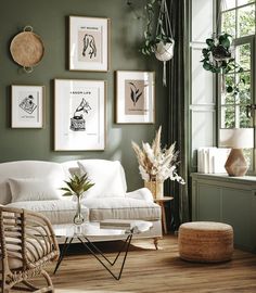 a living room with green walls and pictures on the wall above the white couches